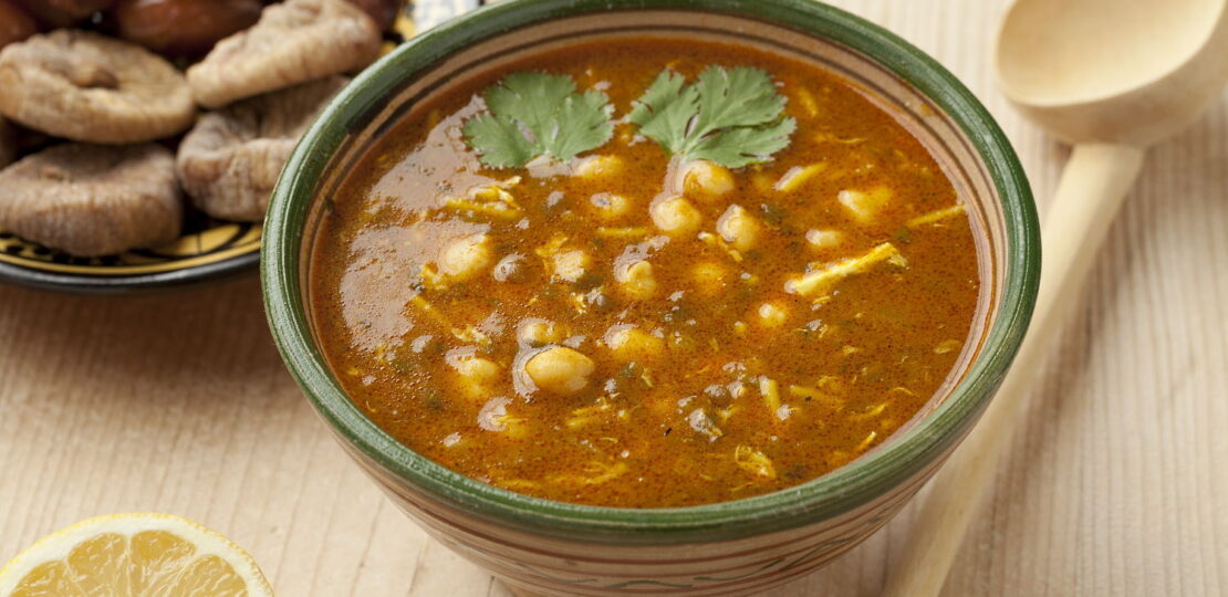 Bowl of Moroccan harira soup, lemon, dates and figs for iftar